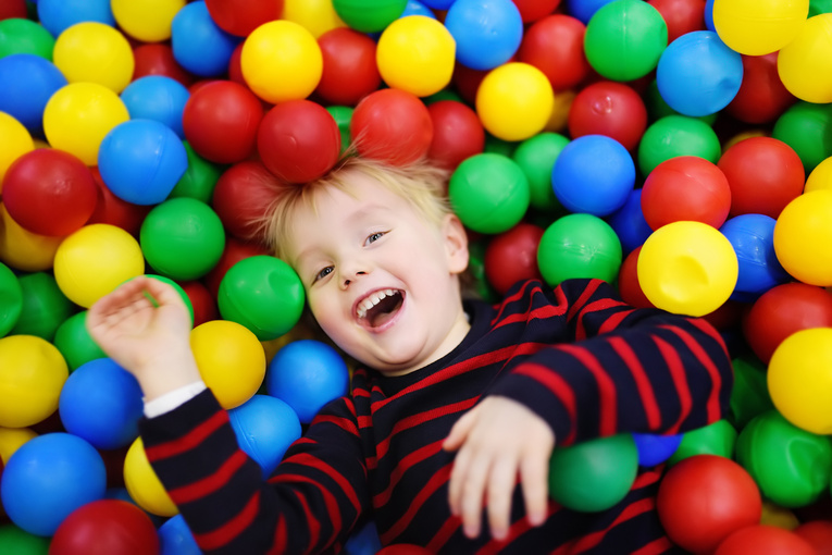 Happy Little Boy Having Fun in Ball Pit 