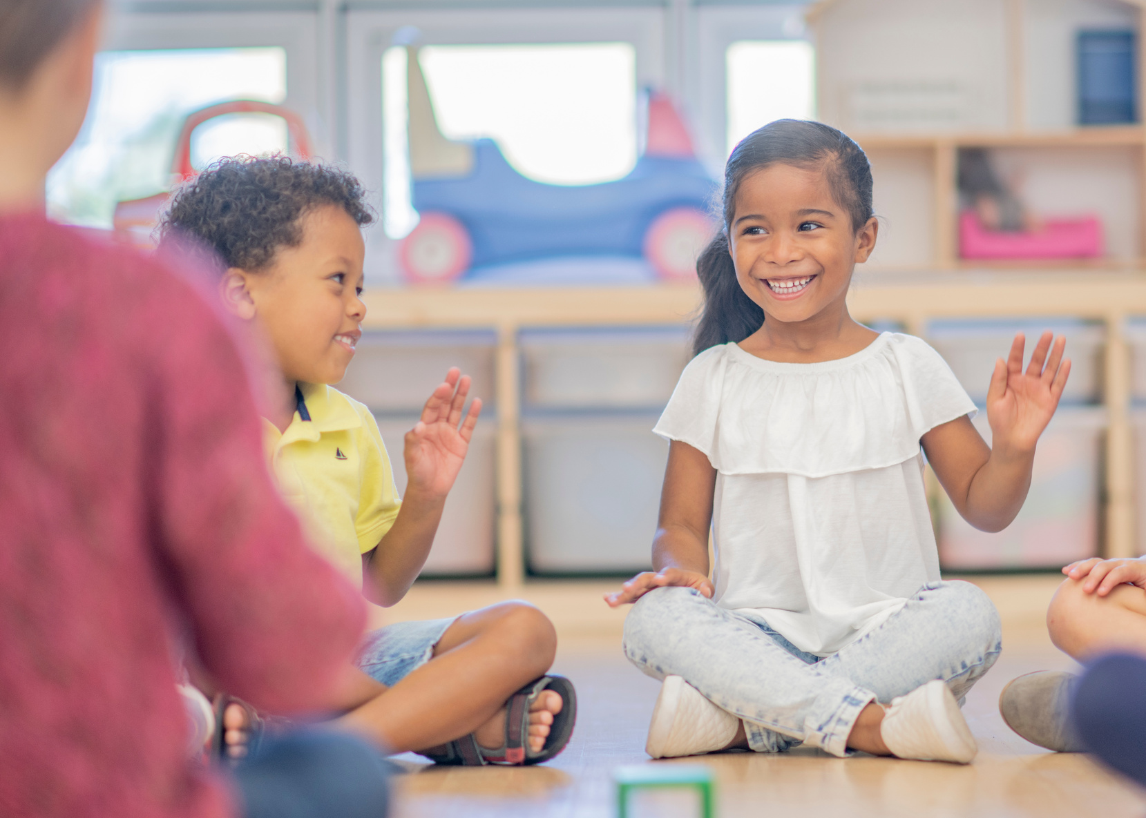 Children waving in kindergarten class